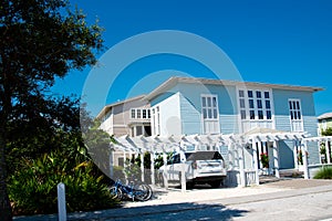 Typical two-story houses with white pergola, picket fence curb appeal along scenic 30A country road in Santa Rosa, South Walton,