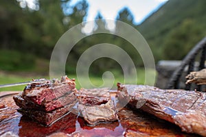 Typical Uruguayan and Argentine Asado Cooked on fire. Entrana and Vacio meat cuts. Accompanied with Chorizo photo