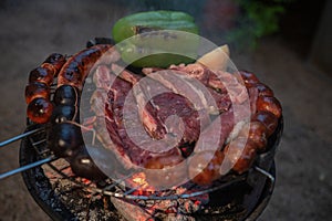 Typical Uruguayan and Argentine Asado Cooked on fire. Entrana and Vacio meat cuts. Accompanied with Chorizo