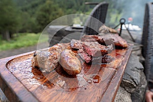 Typical Uruguayan and Argentine Asado Cooked on fire. Entrana and Vacio meat cuts. Accompanied with Chorizo photo