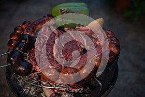 Typical Uruguayan and Argentine Asado Cooked on fire. Entrana and Vacio meat cuts. Accompanied with Chorizo photo