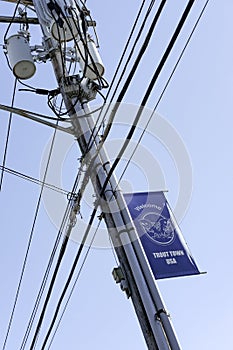 Typical US style power cables seen atop a newly installed pole.