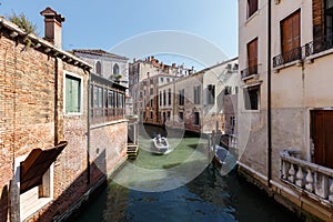 Typical view of boat with passengers on the canal of Venice. Sunny summer day