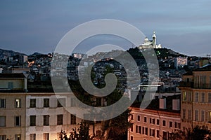 Typical view of Notre Dame de la Garde basilica in Marseille, France, from Saint Charles district at dusk photo