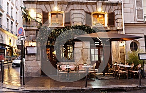 Typical view of the Parisian street with tables of cafe in Paris, France. Architecture and landmark of Paris.