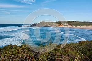 Typical western Algarvian landscape. Stormy ocean and lonely beach. Portugal