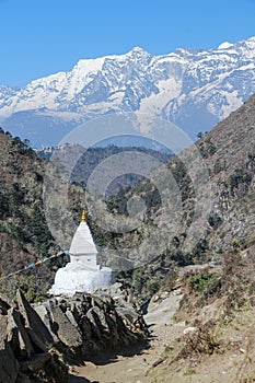 Typical white buddhist stupa near footpath to Everest base camp in Nepal photo