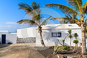 Typical white Canarian house with palm trees
