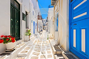 Typical white Greek houses with blue doors and windows on street of beautiful Mykonos town, Cyclades islands, Greece