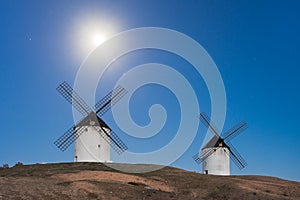 Typical windmill in with the moon at the background