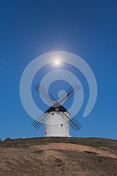 Typical windmill in with the moon at the background