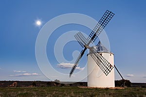 Typical windmill in with the moon at the background