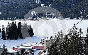 A typical winter idyll on the frozen and snow-covered alpine lake Heidsee (Igl Lai) in the winter resort Lenzerheide