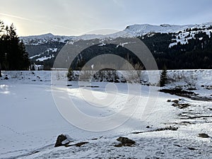 A typical winter idyll on the frozen and snow-covered alpine lake Heidsee (Igl Lai) in the winter resort Lenzerheide