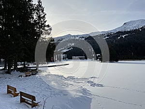 A typical winter idyll on the frozen and snow-covered alpine lake Heidsee (Igl Lai) in the winter resort Lenzerheide