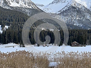 A typical winter idyll on the frozen and snow-covered alpine lake Heidsee (Igl Lai) in the winter resort Lenzerheide