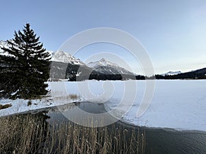 A typical winter idyll on the frozen and snow-covered alpine lake Heidsee (Igl Lai) in the winter resort Lenzerheide