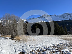 A typical winter idyll on the frozen and snow-covered alpine lake Heidsee (Igl Lai) in the winter resort Lenzerheide