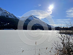 A typical winter idyll on the frozen and snow-covered alpine lake Heidsee (Igl Lai) in the winter resort Lenzerheide