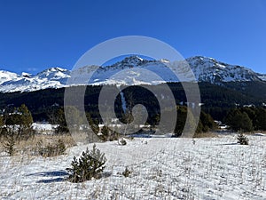 A typical winter idyll on the frozen and snow-covered alpine lake Heidsee (Igl Lai) in the winter resort Lenzerheide