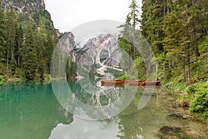 Typical wooden boats on Lake Braies with mist