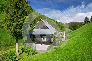 Typical wooden house in mountain village Prasnica near Stare Hory