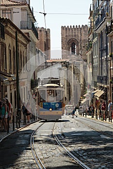 Typical Yellow Vintage Tram in Narrow Street of Lisbon, Portugal.