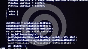 Typing blue source code of computer program on dark display, programming, developer or code concept
