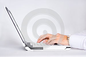 Typing on a laptop