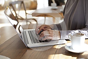 Typing laptop in cafe horizontal