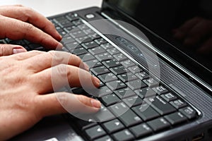 Typing on a laptop computer