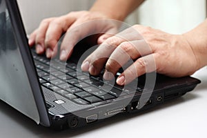 Typing on a laptop computer