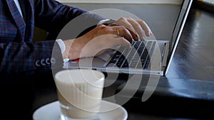 Typing on a laptop keyboard in close-up. Hands typing on computer keys