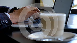 Typing on a laptop keyboard in close-up. Hands typing on computer keys