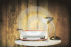 Typing machine and lamp on wood