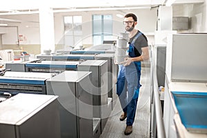 Typographer with paint buckets at the manufacturing