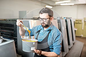 Typographer with paint at the manufacturing