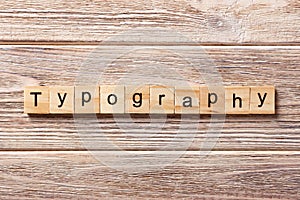 Typography word written on wood block. typography text on table, concept