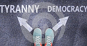 Tyranny and democracy as different choices in life - pictured as words Tyranny, democracy on a road to symbolize making decision photo
