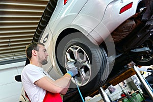 Tyre change on the car in a workshop by a mechanic