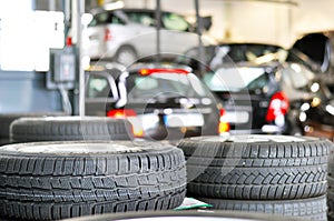 Tyre change in a garage - closeup tyre tread - stack tyres for s