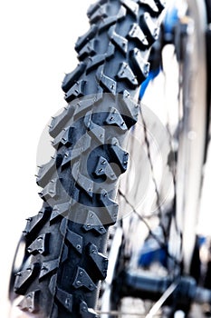 Tyre from a mountain bike against a white background, detail close up, vertical