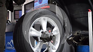 Tyre rotation at balance machine tire. Footage. Tire changer. Seasonal automobile tire change and wheel repair at the