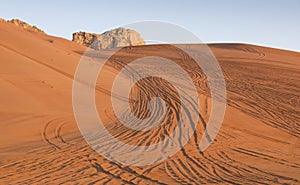 Tyre tracks inthe desert at sunrise