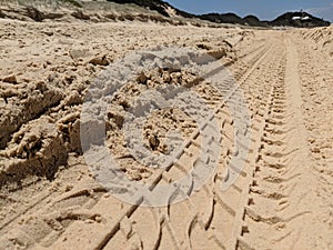 Tyre Tracks In The Sand On The Beach