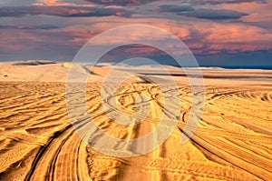 Tyre tracks in sand desert with beautiful sky background