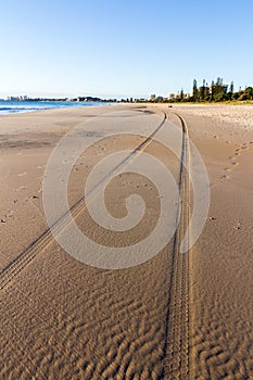 Tyre tracks in the sand, Surfer`s Paradise, Gold Coast, Queensland, Australia photo