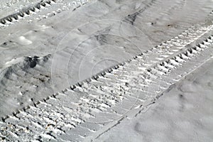 Tyre tracks on snowy road.