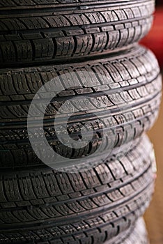 Tyres, pile and wheel in garage for repairs, rubber and fixing or replace fitting on car at shop. Closeup, store and