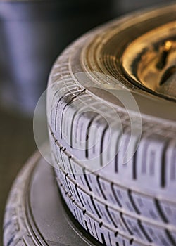 Tyres, stack and wheel in garage for repair, rubber and fixing or replace fitting on car at shop. Closeup, workshop and